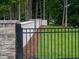Landscaped backyard is enclosed by a decorative stone and iron fence, creating a private and secure outdoor space at 4955 Chamblee Dunwoody Rd, Dunwoody, GA 30338