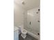 Bathroom featuring a modern glass enclosed shower, white subway tile, and stone flooring at 4955 Chamblee Dunwoody Rd, Dunwoody, GA 30338