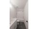 Cozy bathroom featuring a tiled shower and tub, vanity with chrome finishes, and stone flooring at 4955 Chamblee Dunwoody Rd, Dunwoody, GA 30338