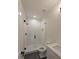 Contemporary bathroom showcasing a glass shower with pebble floor and subway tile, enhancing elegance at 4955 Chamblee Dunwoody Rd, Dunwoody, GA 30338