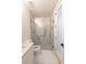Modern bathroom featuring a glass shower enclosure, marble-style tiling, and a white vanity at 4955 Chamblee Dunwoody Rd, Dunwoody, GA 30338
