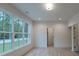 Bright bedroom featuring large windows, providing abundant natural light and scenic backyard views at 4955 Chamblee Dunwoody Rd, Dunwoody, GA 30338