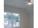 Bright bedroom featuring a ceiling fan and large windows, plus backyard views at 4955 Chamblee Dunwoody Rd, Dunwoody, GA 30338