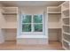 Custom closet with ample storage, shelving, window seat, and natural light at 4955 Chamblee Dunwoody Rd, Dunwoody, GA 30338