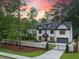 Stunning two-story home features a manicured front yard, driveway, and a gated entrance at 4955 Chamblee Dunwoody Rd, Dunwoody, GA 30338