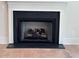 Close-up of modern fireplace with black trim and stone surround, creating a cozy focal point in the home at 4955 Chamblee Dunwoody Rd, Dunwoody, GA 30338