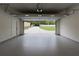 Open garage overlooking a paved driveway, manicured lawn and wooded backyard at 4955 Chamblee Dunwoody Rd, Dunwoody, GA 30338