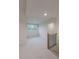 Bright hallway with a window and modern railing provides natural light and stylish architectural details at 4955 Chamblee Dunwoody Rd, Dunwoody, GA 30338