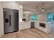 Bright kitchen with stainless steel appliances, white cabinets, and hardwood floors at 4955 Chamblee Dunwoody Rd, Dunwoody, GA 30338