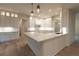 Modern kitchen with white cabinets, an island, and hardwood floors at 4955 Chamblee Dunwoody Rd, Dunwoody, GA 30338