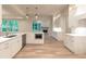 Bright kitchen with white cabinets, stainless steel appliances, and a view of the fireplace at 4955 Chamblee Dunwoody Rd, Dunwoody, GA 30338