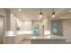 Bright kitchen with island, pendant lighting and modern appliances at 4955 Chamblee Dunwoody Rd, Dunwoody, GA 30338