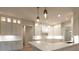 Bright, all-white kitchen with bar seating, pendant lighting and updated appliances at 4955 Chamblee Dunwoody Rd, Dunwoody, GA 30338