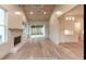 This open-concept living room boasts a fireplace, hardwood floors, and a view into the bright kitchen at 4955 Chamblee Dunwoody Rd, Dunwoody, GA 30338