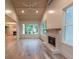 Bright living room with a fireplace, large windows, wood ceilings and shiplap walls at 4955 Chamblee Dunwoody Rd, Dunwoody, GA 30338