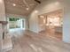 Open-concept living room with wood-paneled ceiling and fireplace, flowing into the kitchen at 4955 Chamblee Dunwoody Rd, Dunwoody, GA 30338