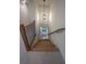 Staircase with carpeted steps, wooden banister and black metal spindles with a window at the bottom of the stairs at 4955 Chamblee Dunwoody Rd, Dunwoody, GA 30338