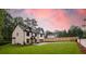 Exterior side-view of a house with a spacious green lawn, enclosed by a fence at 4955 Chamblee Dunwoody Rd, Dunwoody, GA 30338