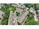 An aerial view of a well-manicured townhouse community surrounded by lush green trees and landscaping at 565 Rose Garden Ln, Alpharetta, GA 30009