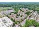 A beautiful aerial view of a neighborhood with tree lined streets and meticulously maintained townhomes at 565 Rose Garden Ln, Alpharetta, GA 30009