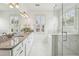 Beautiful bathroom with granite countertops, dual sinks, and a frameless glass shower with marble tile at 565 Rose Garden Ln, Alpharetta, GA 30009