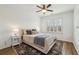Cozy bedroom with a neutral color palette, plush bedding, and a ceiling fan for a comfortable and relaxing atmosphere at 565 Rose Garden Ln, Alpharetta, GA 30009