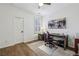 Bedroom or Office space features wood floors, shutters, a desk and is bright, with a view of the street at 565 Rose Garden Ln, Alpharetta, GA 30009