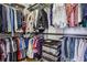 Walk-in closet with custom shelving and hanging rods to maximize storage space for clothes, shoes, and accessories at 565 Rose Garden Ln, Alpharetta, GA 30009