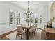 Elegant dining room featuring hardwood floors, natural light from the windows, and stylish decor at 565 Rose Garden Ln, Alpharetta, GA 30009