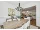 Bright dining room features a modern chandelier and flows into the adjacent kitchen and living spaces at 565 Rose Garden Ln, Alpharetta, GA 30009