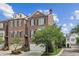 Charming brick townhome with a two-car garage and well-manicured landscaping at 565 Rose Garden Ln, Alpharetta, GA 30009