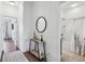 Bright hallway with hardwood floors, a decorative table, and views into a well-appointed bathroom with a shower and tub at 565 Rose Garden Ln, Alpharetta, GA 30009