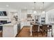 Bright kitchen featuring marble counters, stainless steel appliances, and an open layout to the living area at 565 Rose Garden Ln, Alpharetta, GA 30009