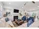 Bright, open living room with hardwood floors, fireplace, and seamless flow into the kitchen and dining area at 565 Rose Garden Ln, Alpharetta, GA 30009