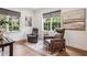 Cozy living room showcasing wood floors, natural light, and two comfortable leather armchairs at 565 Rose Garden Ln, Alpharetta, GA 30009
