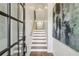 Inviting entryway with stairs featuring wood treads, white risers, and stylish decor at 565 Rose Garden Ln, Alpharetta, GA 30009