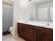 Bathroom featuring a double vanity with wood cabinets, white countertops and a shower at 1110 Cureton Dr, Austell, GA 30106