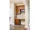 Butler pantry with dark wood cabinets, tile backsplash, drawers and ample storage for seamless entertaining at 1110 Cureton Dr, Austell, GA 30106