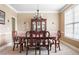 Formal dining room with wood table, chairs, china cabinet, and a window at 1110 Cureton Dr, Austell, GA 30106