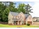 Charming two-story brick home with a well-manicured lawn, inviting front porch, and attached garage at 1110 Cureton Dr, Austell, GA 30106