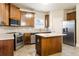 Kitchen featuring stainless steel appliances, wood cabinets, ample counter space, and an island at 1110 Cureton Dr, Austell, GA 30106