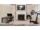 Cozy living room with fireplace, television, desk, and treadmill in a comfortable setting at 1110 Cureton Dr, Austell, GA 30106
