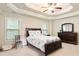 Comfortable main bedroom with a decorative tray ceiling, carpet flooring, and natural light at 1110 Cureton Dr, Austell, GA 30106