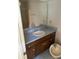 Bathroom featuring a sink, medicine cabinet, mirror, and shower with tile surround at 1481 Yates Cv, Lawrenceville, GA 30043