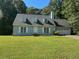 Charming single-Gathering home featuring a well-manicured lawn and attached two car garage at 1481 Yates Cv, Lawrenceville, GA 30043