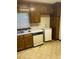 This kitchen features stained wood cabinets, a double basin sink, and laminate countertop at 1481 Yates Cv, Lawrenceville, GA 30043