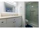 Bathroom featuring white cabinets, a large mirror, and a modern glass-enclosed shower at 215 Summit North Ne Dr, Atlanta, GA 30324
