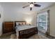 Comfortable bedroom features a ceiling fan and a window view of a landscaped yard at 215 Summit North Ne Dr, Atlanta, GA 30324
