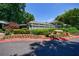 Inviting clubhouse with meticulously landscaped grounds, including flowers and shrubs at 215 Summit North Ne Dr, Atlanta, GA 30324