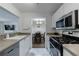 Bright kitchen features stainless appliances, white cabinetry, and open view to dining area at 215 Summit North Ne Dr, Atlanta, GA 30324